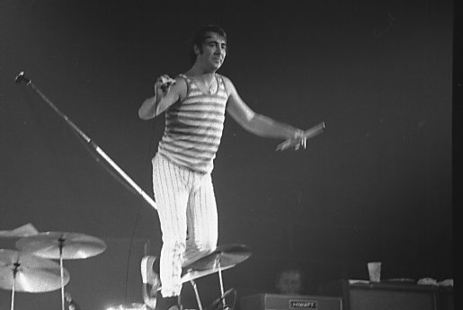 Keith Moon standing on drum kit